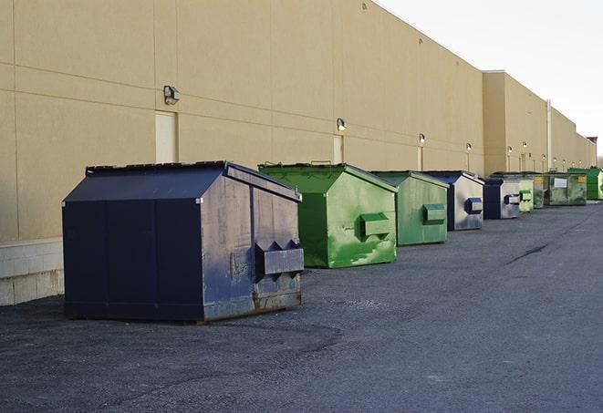 a row of heavy-duty dumpsters ready for use at a construction project in Round Rock, TX